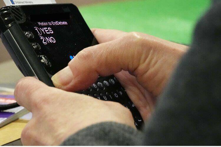 A delegate votes at the 2020 General Conference