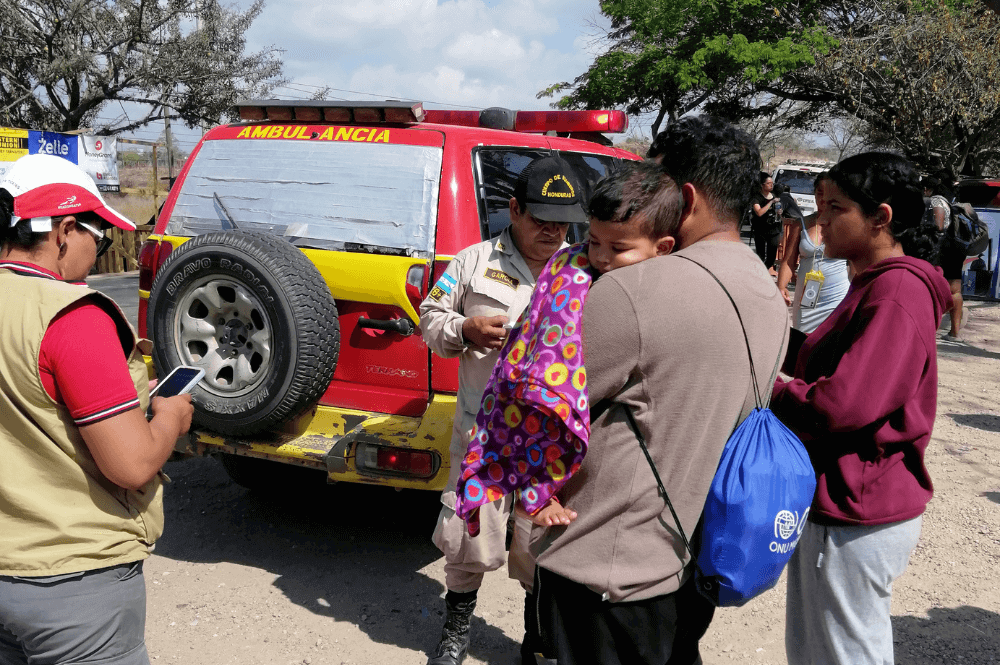 A young couple waits as Honduran officials and a staff member from the United Methodist Mission in Honduras clinic prepare an ambulance to take their sick son to the hospital. (Photo: Courtesy of UMMH)