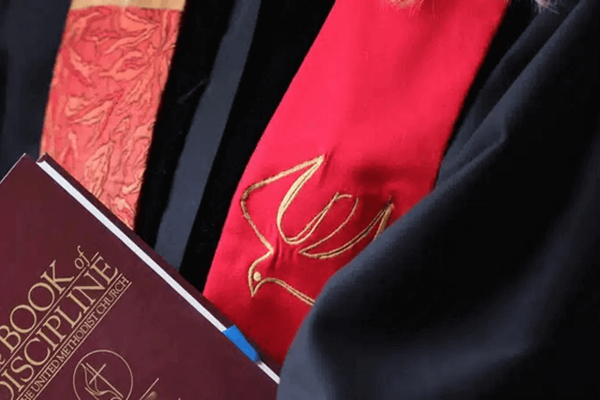 A clergy member holds the Book of Discipline. Photo courtesy of General Board of Higher Education and Ministry.