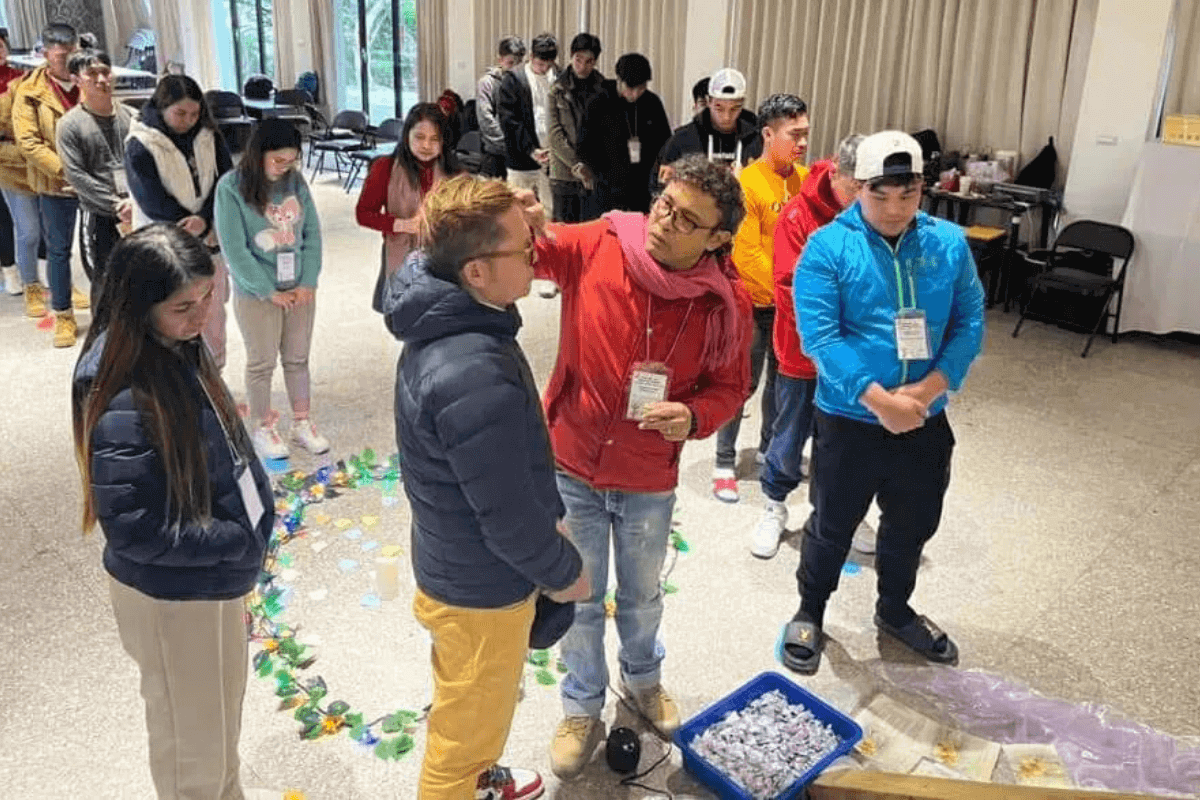 The Rev. Richard Navarro (red sweater) leads worshipers through a spiritual exercise at a TAHANAN event. Photo courtesy of Chadash Matthew Navarro.
