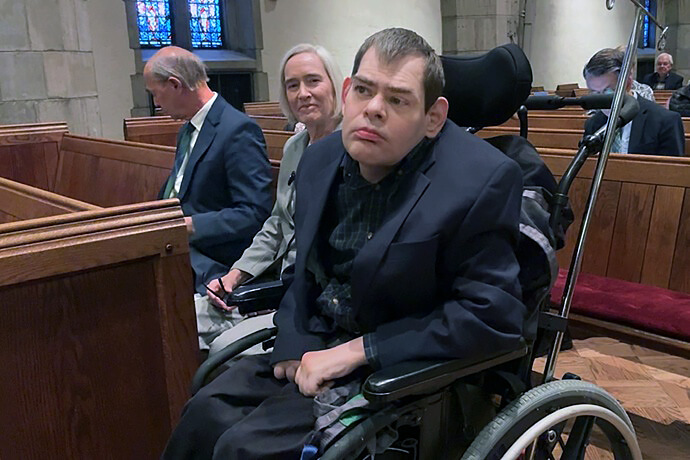 Powell Richardson and his family sit in a special row in the sanctuary of Church Street United Methodist in Knoxville, Tenn. Church Street recently added designated spaces to better accommodate persons in wheelchairs. Photo from video by Lilla Marigza, UM News.