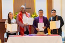 From left: The Rev. Allison Mark, Bishop Julius C. Trimble, Bishop Israel M. Painit, and Pastor Thaad Kolin Samson hold up the signed agreement.