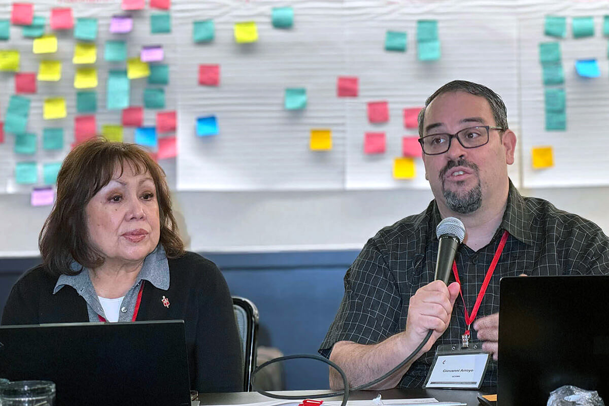 Bishop Minerva Carcaño (left), chair of the United Methodist Immigration Task Force, listens as the Rev. Giovanni Arroyo, top staff executive of the United Methodist Commission on Religion and Race, speaks during the United Methodist Immigration Task Force meeting, held Nov. 18-20 in Los Angeles. The gathering brought together church agencies, migrant ministries, bishops and ecumenical partners to strengthen coordinated advocacy. Photo by the Rev. Gustavo Vasquez, UM News.