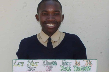 Darven Mutoyi, 16, showcases his prize-winning artwork in a competition aimed to promote awareness of the dangers of drug abuse. The competition was held Oct. 16 at Chinyauhwera High School in The United Methodist Church’s Zimunya Central Circuit, in the Mutare area of Zimbabwe, as part of the Pillars & Plants program. Photo by Kudzai Chingwe.