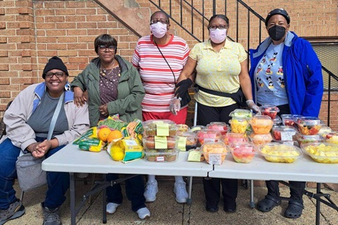 Volunteers offer their time and food at a "Pop-up Wednesday" distribution outside St. Luke UMC, Baltimore. Photo courtesy of Angelic Williams.