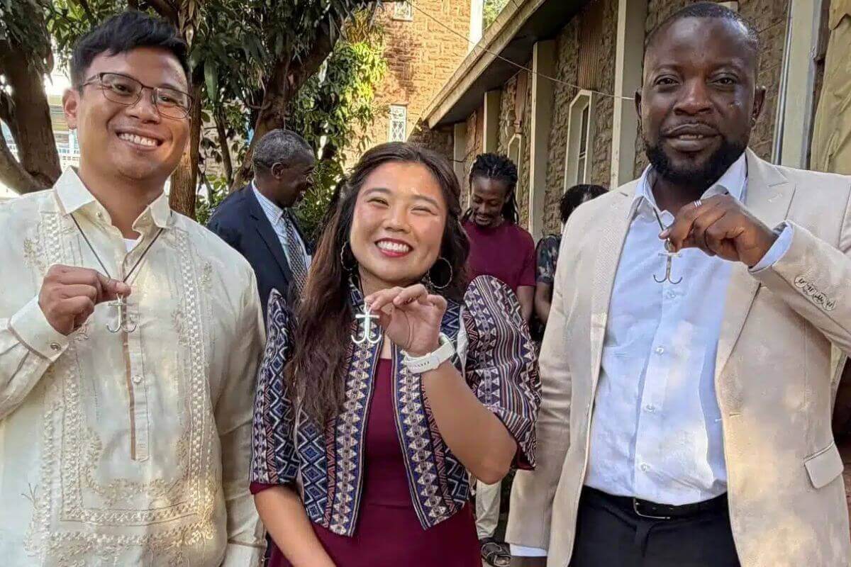 Former Global Mission Fellows, Warren Alfeche, Ellyzsa Valencia and Earnest Mudzengerere show their anchor crosses just after they were commissioned as Global Missionaries in Kenya. Photo courtesy of Global Mission Fellows, GBGM.