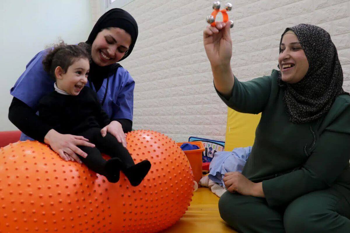 Ruqayya's mother (at right) has learned much about her daughter and how to care for her at the Jerusalem Princess Basma Centre Mother and Family Empowerment program. Photo: Courtesy of the Princess Basma Centre