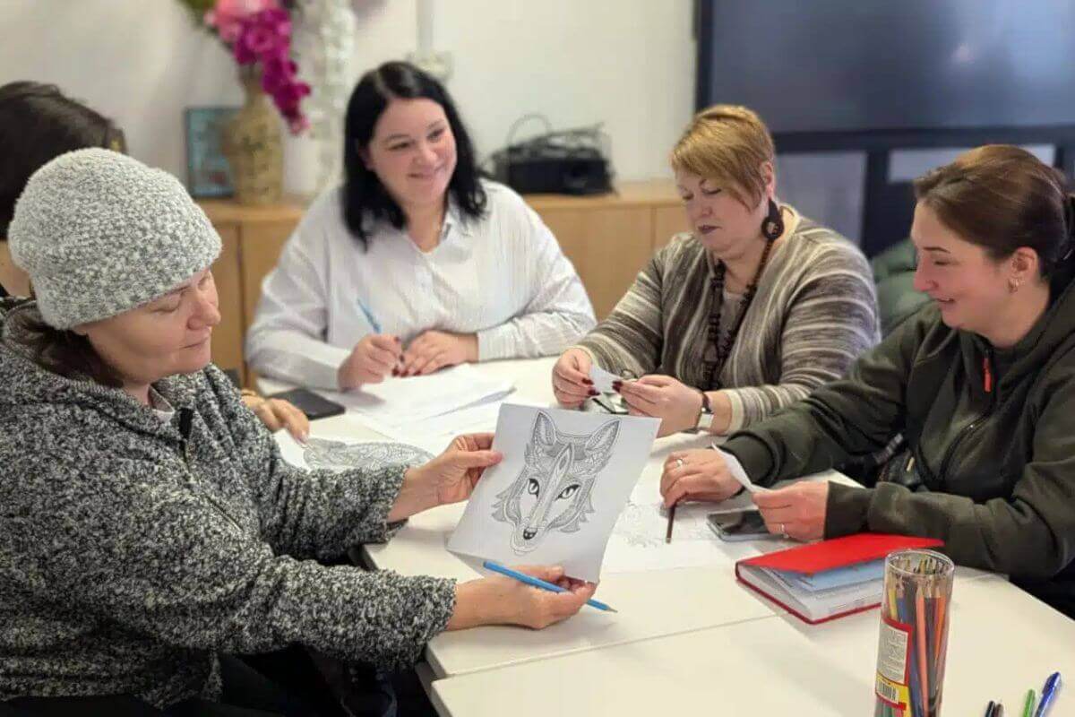 A group of Ukrainian women in Romania participate in a workshop to ease their transition into a new culture and way of life. Photo: AIDRom