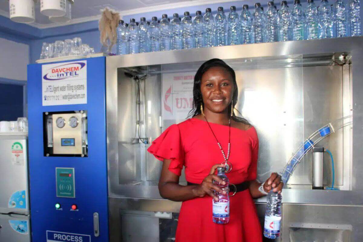 Project Manager Tabitha Waithira, of Trinity UMC in Naivasha, Kenya, demonstrates the water filling station and filtration system funded by an UMCOR grant. Photo: Kudzai Chingwe
