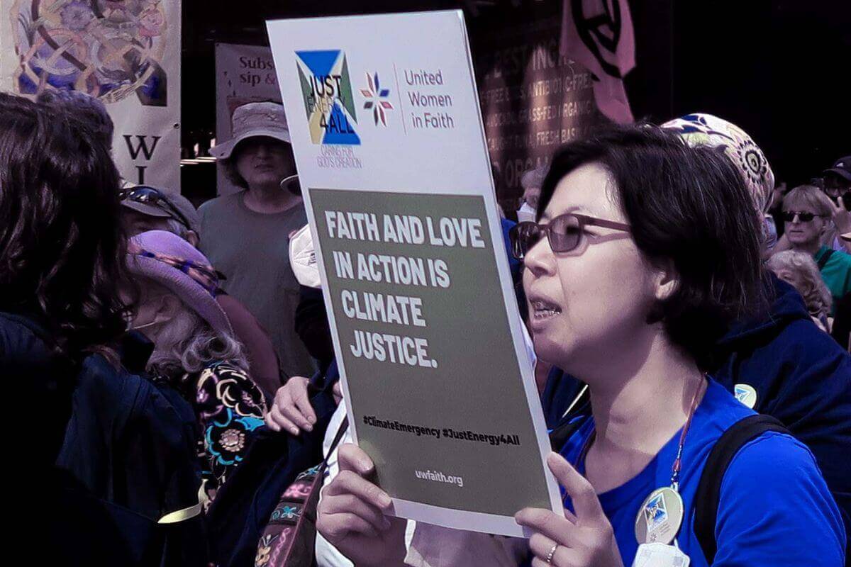 Elizabeth Chun Hye Lee, United Women in Faith’s director of mobilization and advocacy, displays a sign as she participates in the End Fossil Fuels Climate March, September 17, 2023, in New York City. Photo courtesy of Samantha Nyachoto.