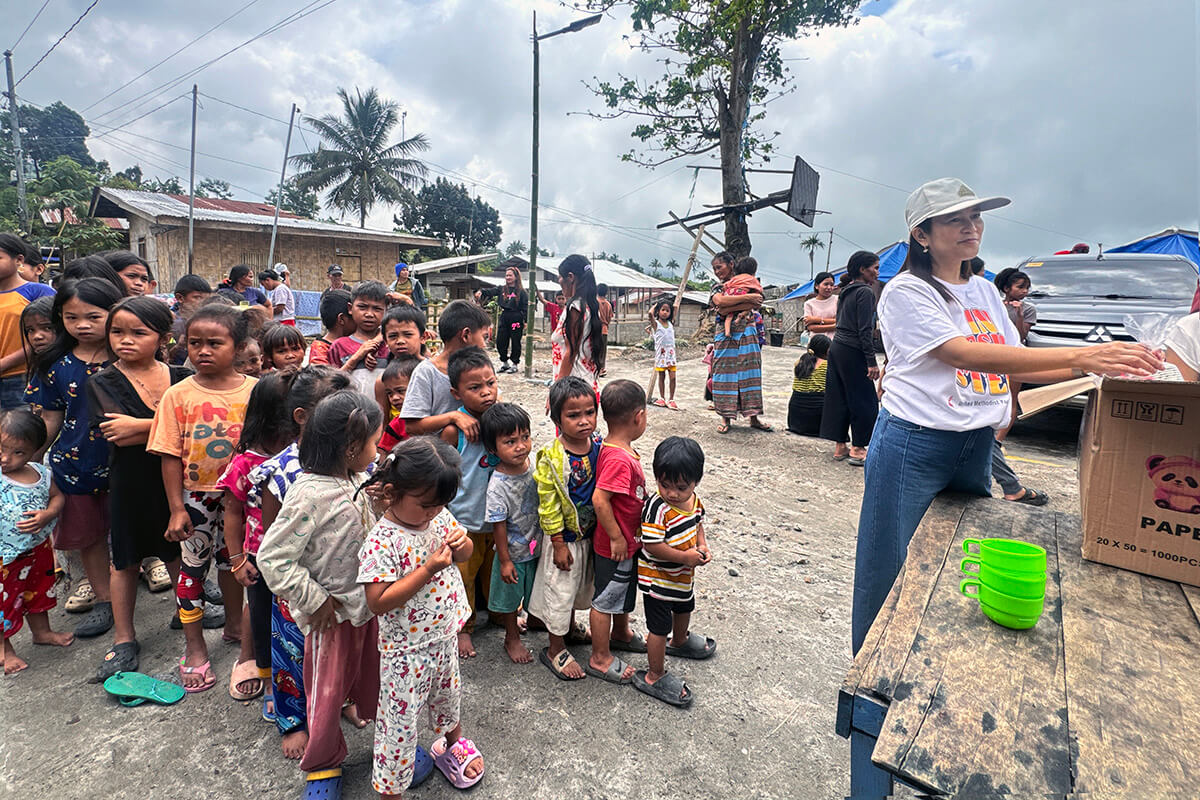 Suzette Marzo with the United Methodist Young Adult Fellowship prepares to distribute food to children during a relief operation in Sarangani province, Philippines, after a deadly 7.8 magnitude earthquake struck Southern Mindanao on June 8, leaving many in the region displaced. The efforts were led by Central United Methodist Church of General Santos City. Photo courtesy of Marife Cambel. 
