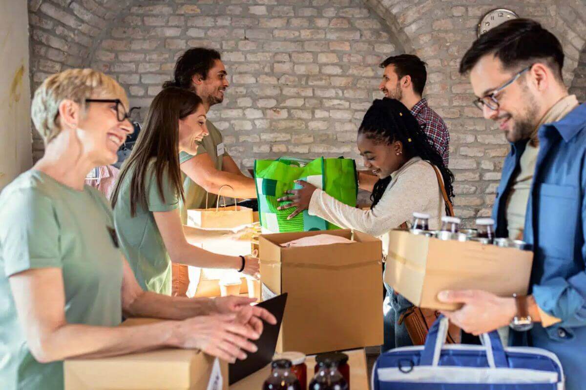 Group of volunteers with face mask working in community charity donation center. Photo provided by GBGM.