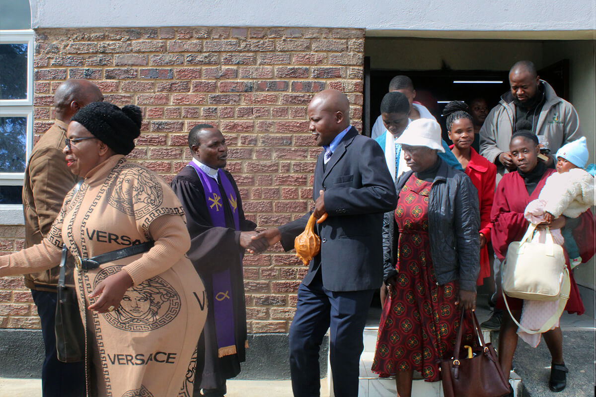 The Rev. Cosmas Chafanza (third from left) greets members after church service at Magamba Circuit’s new sanctuary in Rusape, Zimbabwe. The circuit is seeing growth through its evangelism and outreach efforts. Photo by Kudzai Chingwe, UM News.