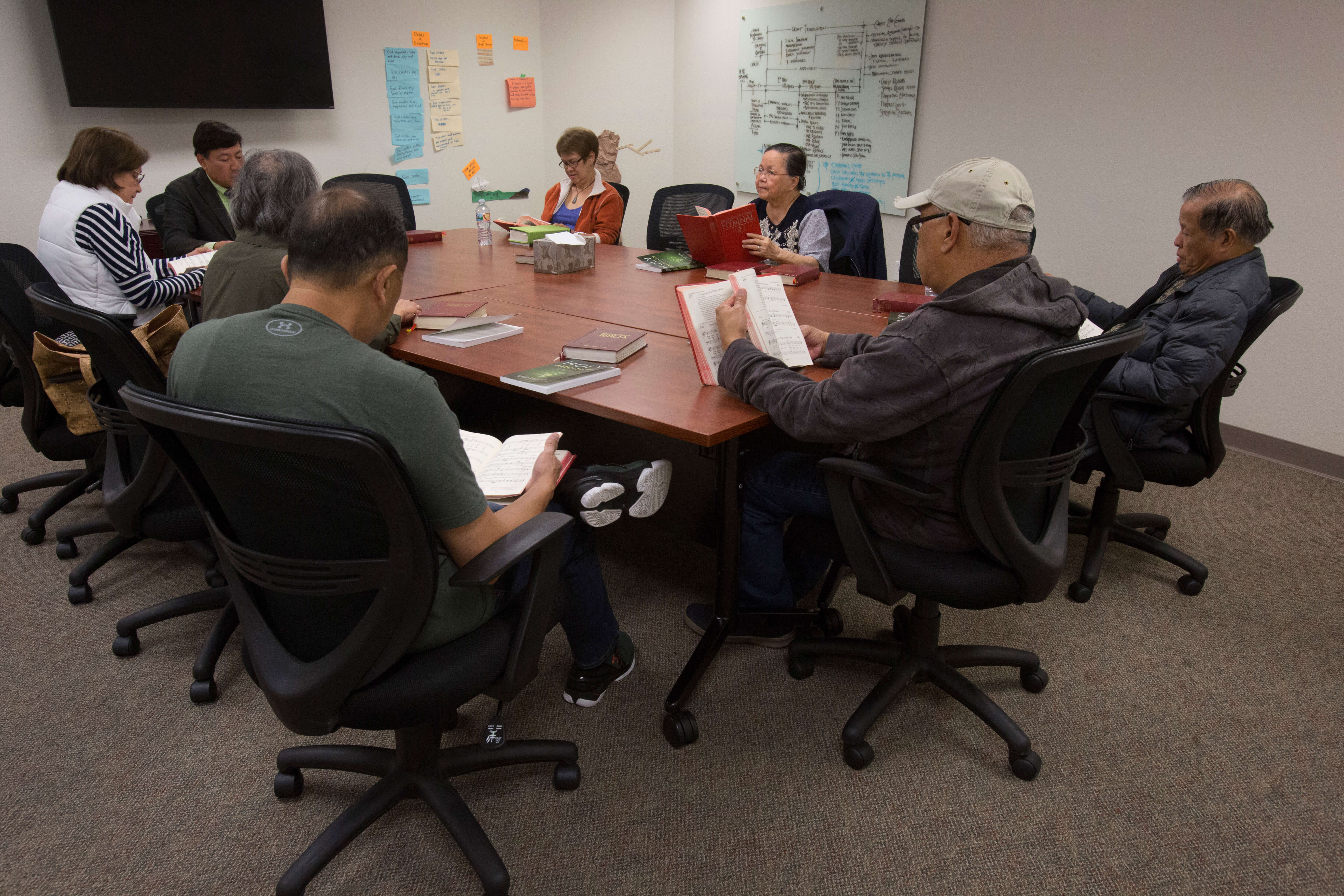 A Bible study group meets at St. Paul United Methodist Church in Fremont, Ca. The Bibles are written in the Tagalog language. Photo by Kathleen Barry, United Methodist Communications
