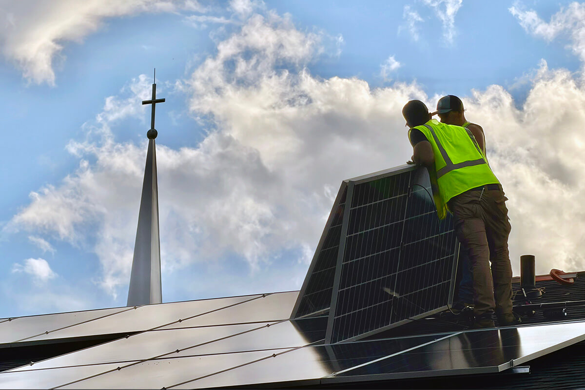 Workers install solar panels at Chamblee United Methodist Church in Chamblee, Ga. The Rev. Blair Zant, senior pastor, said the church has already saved $40,000 since the installation was completed in April of this year. Several other United Methodist churches in Georgia are hooking up to solar power, helped by a nonprofit organization that guides them in setting it up with no upfront costs. Photo courtesy of Chamblee United Methodist Church.
