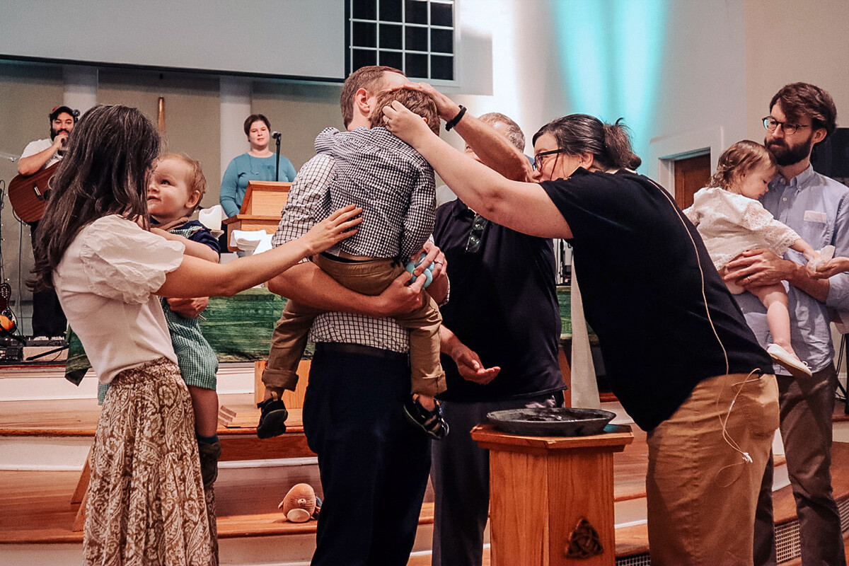 The Rev. Anjie Peek Rivers officiates at a baptism Aug. 9 for the Nichols family at Atlanta’s Eastside Church, one of nine small, thriving United Methodist congregations featured in a new report by Wesleyan Impact Partners. In “Flourishing Small Congregations,” the Texas-based nonprofit challenges The United Methodist Church to see small churches as assets. Eastside also celebrated its 15th anniversary Aug. 9. Photo by Karina Aragon-Buchanan, Eastside Church.