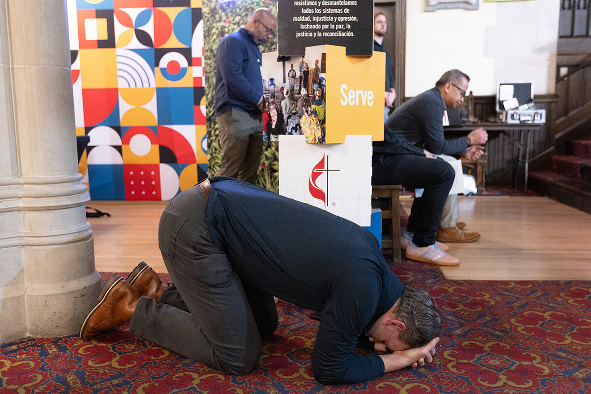 The Rev. Christopher T. McAlilly prays during morning worship Oct. 22 at the United Methodist Leadership Gathering at Knox United Church in Calgary, Canada. Participants spent their second full day together moving from naming the realities facing The United Methodist Church to reflecting on practices to help it thrive. Photo by Mike DuBose, UM News.
